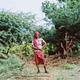 Chitra, a kothi priest from outside of Cuddalore, poses for a portrait while cutting down wood used for cooking. Many kothis choose to do this kind of work—which is traditionally done by women—as another way to express their female identity.